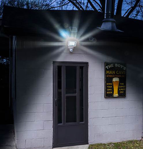 Classy Caps Motion Sensor Solar Security Light illuminates an entrance door