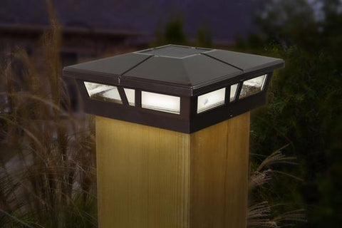 Classy Caps Cambridge Aluminum 6x6 Solar Post Cap Lights installed on wood post at night