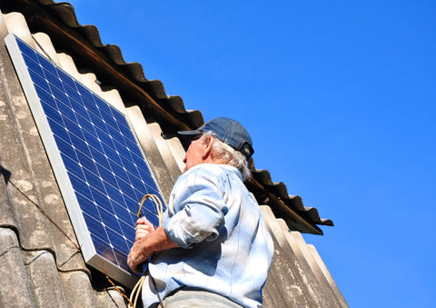 Man installing Nature Power 110 Watt Solar Panels on a structure